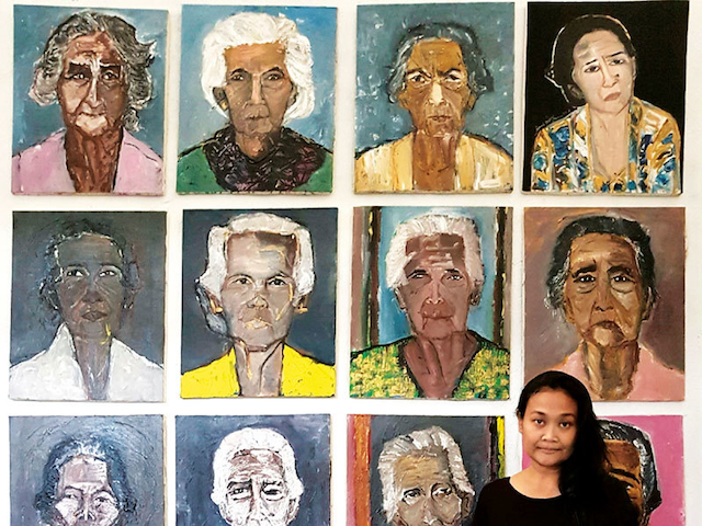 Dewi Candraningrum in front of her painting featuring women survivors of enforced military prostitution in Indonesia during the Japanese Occupation